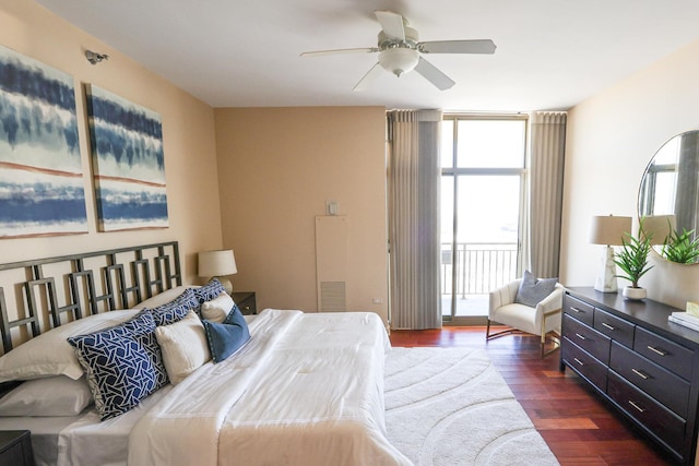 bedroom featuring access to exterior, dark wood-style flooring, floor to ceiling windows, and ceiling fan