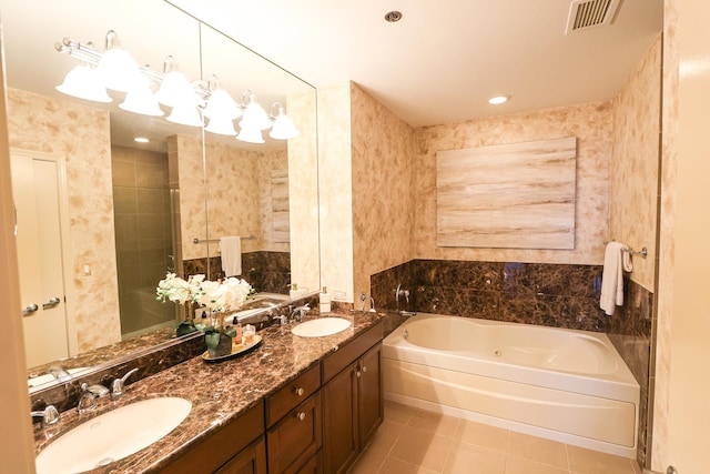 full bath featuring a bath, tile patterned flooring, a sink, and visible vents