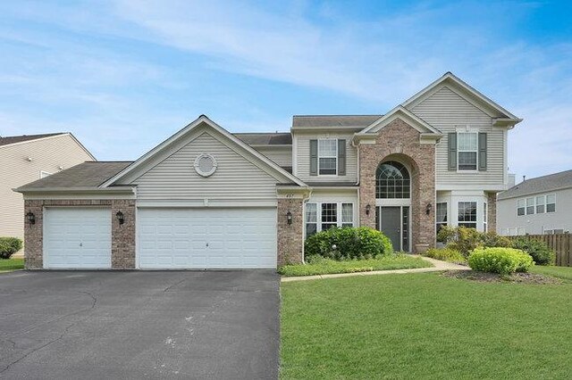 front of property featuring a garage and a front lawn