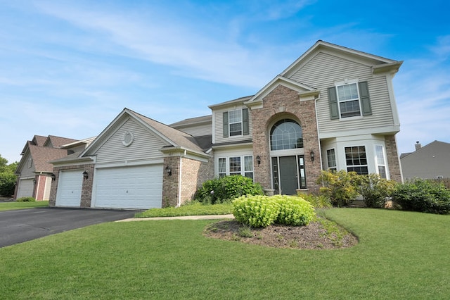 view of front property with a garage and a front lawn