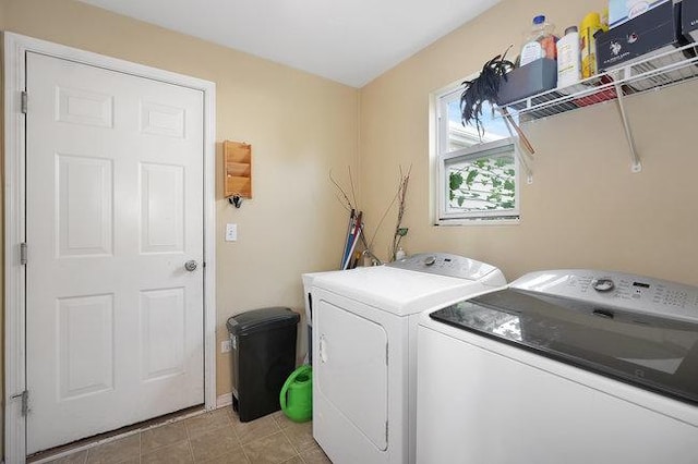 clothes washing area with light tile patterned flooring and washer and clothes dryer