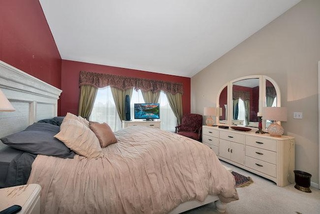 bedroom featuring vaulted ceiling and light colored carpet