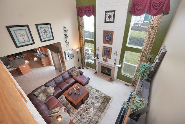 living room with plenty of natural light and a large fireplace