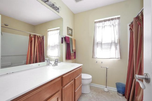 bathroom with vanity, tile patterned floors, and toilet