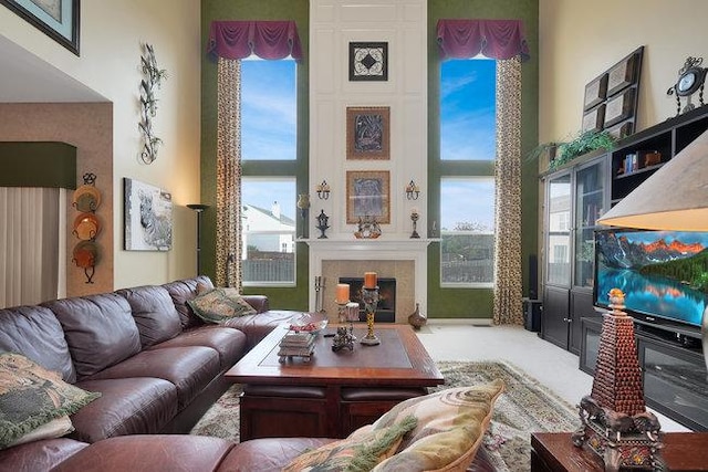 living room featuring a high ceiling and carpet flooring