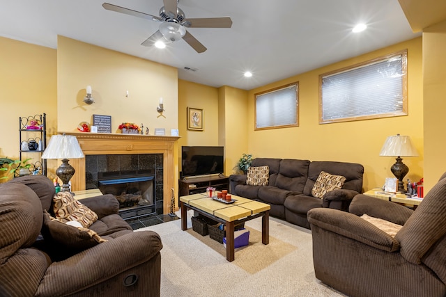 living room with light carpet, a fireplace, and ceiling fan