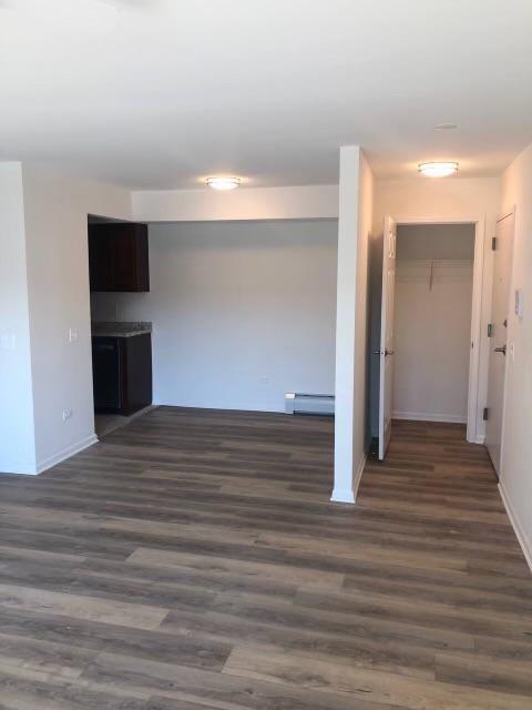 interior space with baseboard heating and dark hardwood / wood-style floors