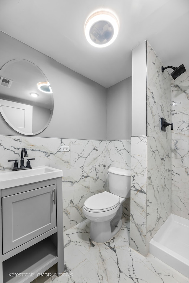 bathroom featuring tile walls, toilet, tile patterned floors, and vanity