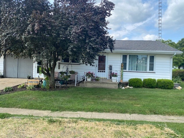 view of front of property with a front lawn and a garage