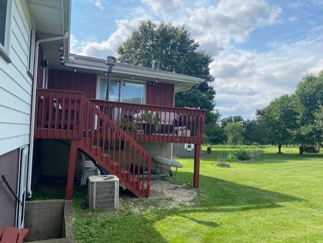 view of yard with stairway, central AC, and a deck