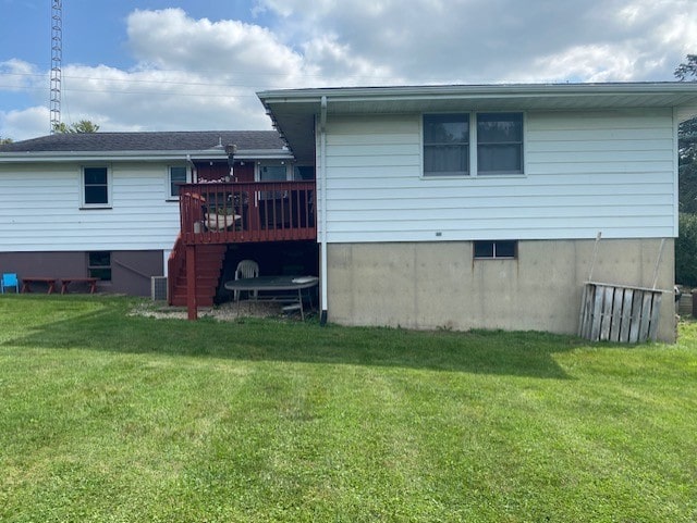 back of house with a lawn and a deck