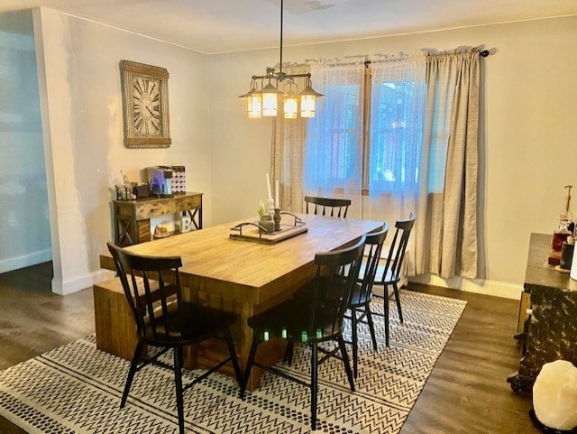 dining area featuring baseboards and wood finished floors