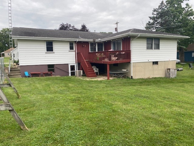 back of property featuring stairs, a yard, and a wooden deck