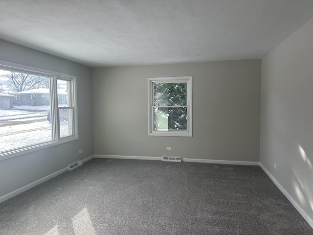 empty room featuring dark carpet