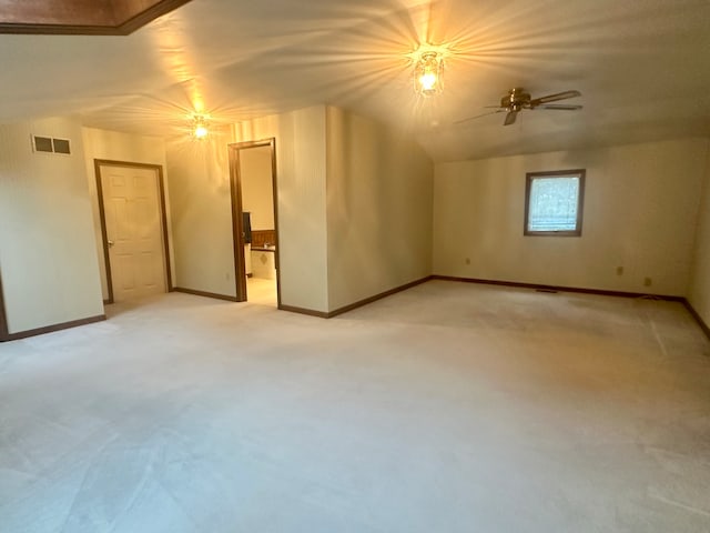 bonus room with ceiling fan and light carpet