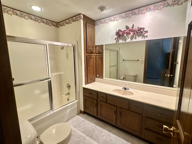 full bathroom featuring toilet, bath / shower combo with glass door, vanity, and tile patterned floors