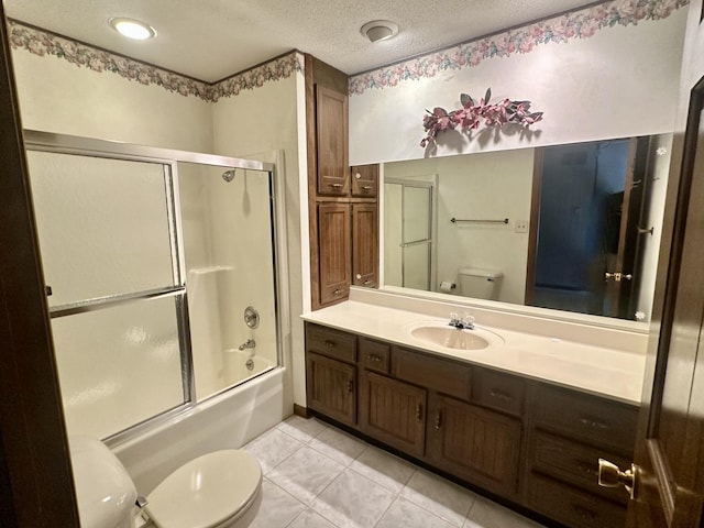 full bath featuring tile patterned floors, toilet, vanity, a textured ceiling, and enclosed tub / shower combo