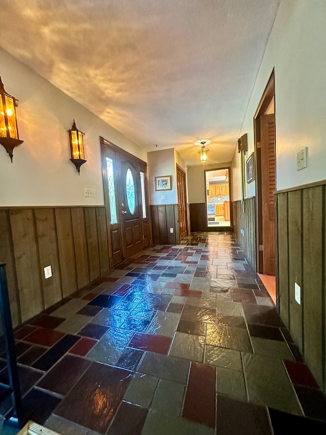 foyer featuring dark tile patterned flooring