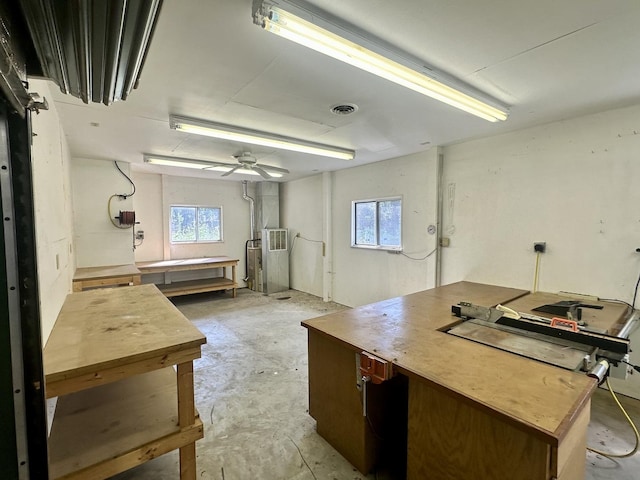 interior space with ceiling fan, visible vents, and plenty of natural light