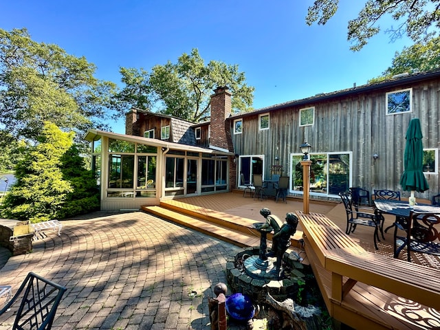 rear view of house featuring a patio and a wooden deck