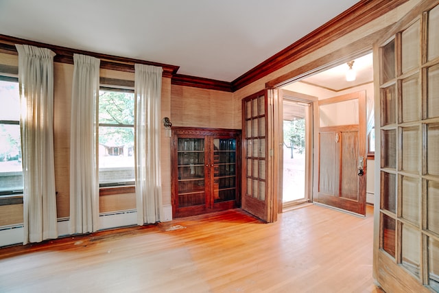 interior space featuring french doors, light hardwood / wood-style flooring, and crown molding