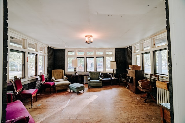 interior space featuring brick wall and radiator heating unit