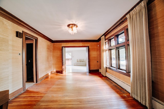 328 E Mulberry St, Watseka, IL 60970 - hallway featuring ornamental molding, light wood finished floors, a baseboard radiator, and baseboards