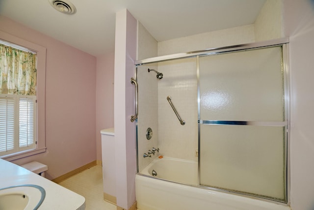 328 E Mulberry St, Watseka, IL 60970 - bathroom featuring shower / bath combination with glass door, vanity, and baseboards