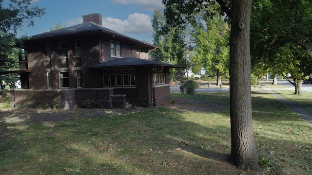 328 E Mulberry St, Watseka, IL 60970 - view of property exterior featuring brick siding, a chimney, and a lawn