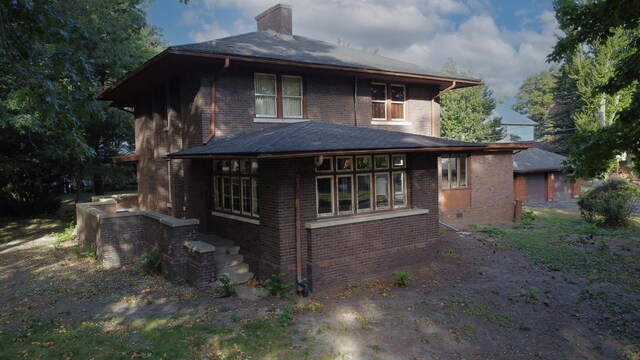 328 E Mulberry St, Watseka, IL 60970 - rear view of house featuring brick siding and a chimney