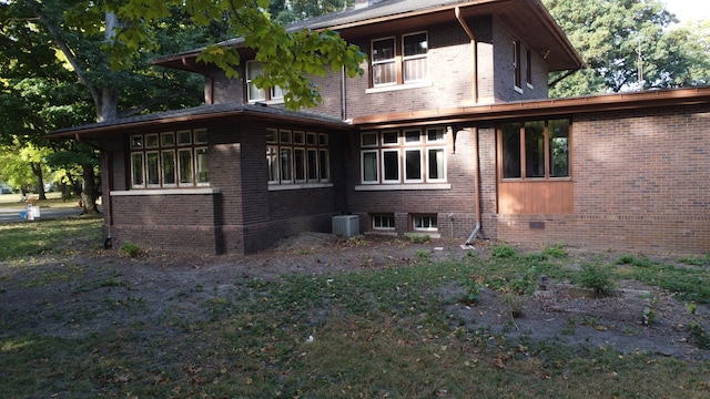 rear view of house with central AC unit