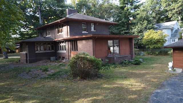 328 E Mulberry St, Watseka, IL 60970 - view of front of property with brick siding, a chimney, a front yard, and central AC