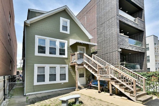 back of house featuring a balcony and a patio area