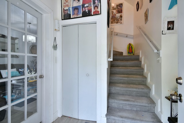 stairs with hardwood / wood-style floors