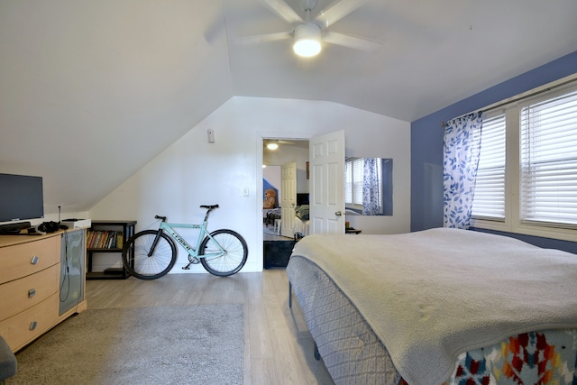 bedroom featuring ceiling fan, vaulted ceiling, and light hardwood / wood-style floors