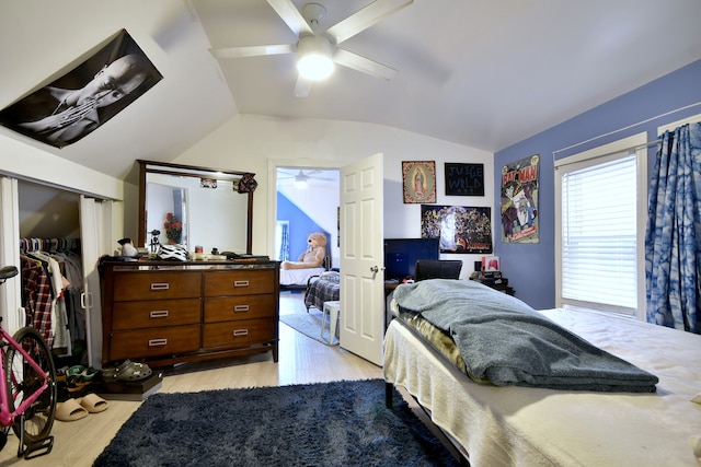 bedroom featuring ceiling fan, vaulted ceiling, light hardwood / wood-style floors, and a closet