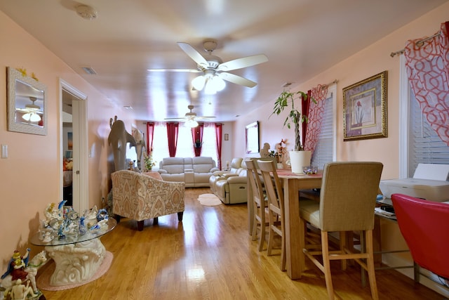 dining room with ceiling fan and light wood-type flooring