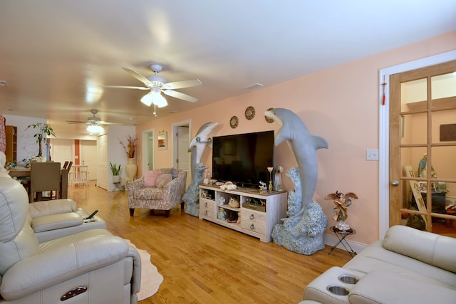 living room with ceiling fan and light wood-type flooring