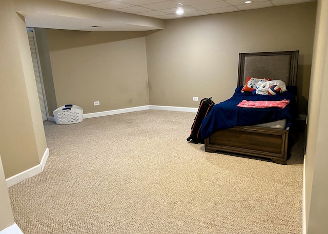 bedroom featuring carpet floors and a drop ceiling