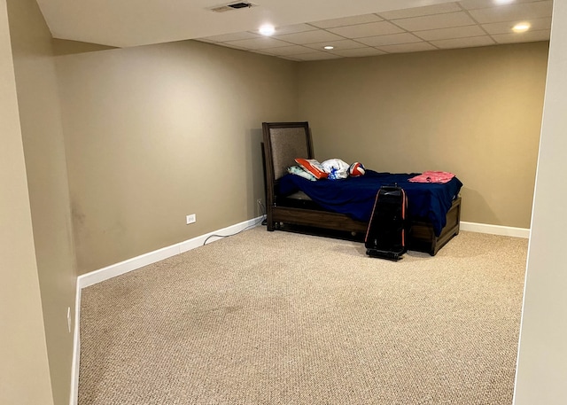 bedroom with carpet and a paneled ceiling