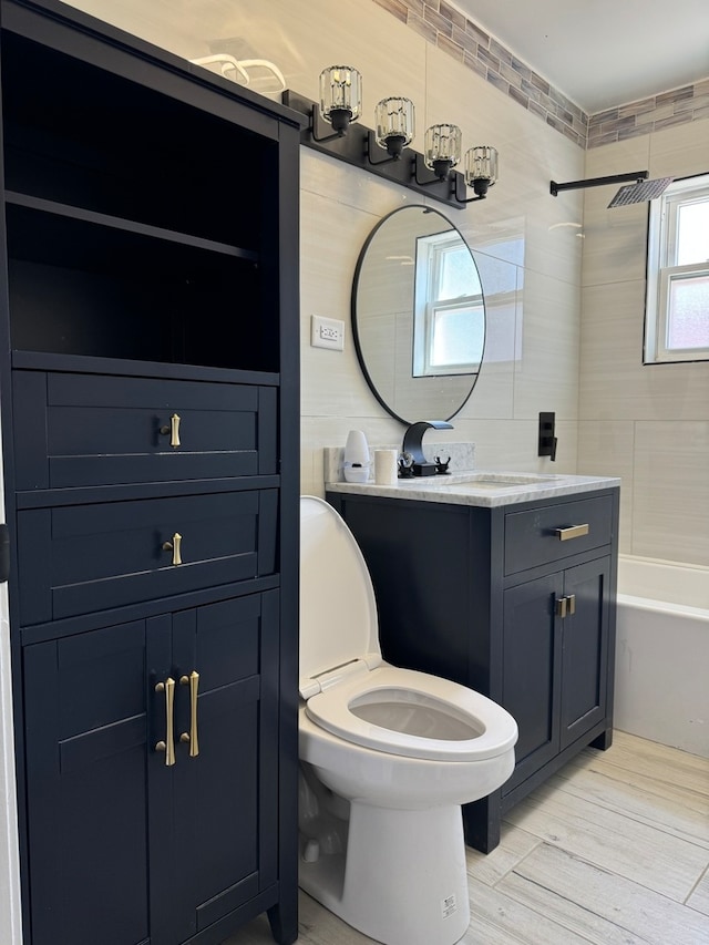 full bathroom with shower / washtub combination, vanity, toilet, and wood finished floors