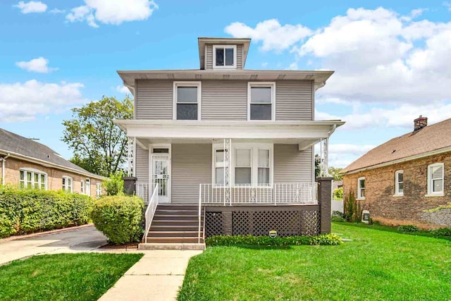 view of front of house with a front yard and covered porch