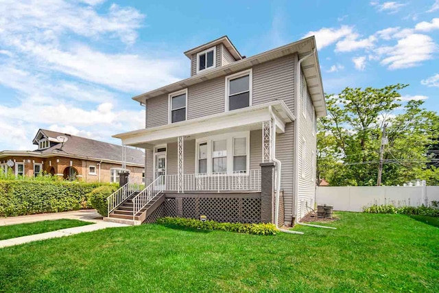 view of front of property featuring covered porch and a front lawn