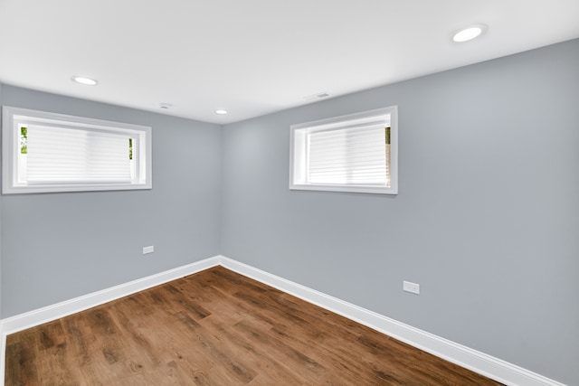 empty room with hardwood / wood-style flooring