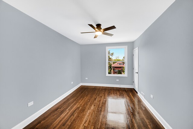 spare room featuring ceiling fan and dark hardwood / wood-style flooring