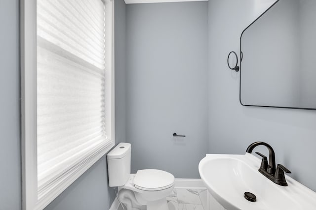 bathroom with sink, tile patterned flooring, and toilet