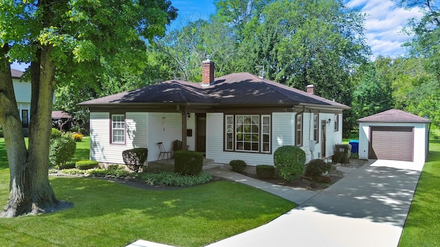 view of front facade featuring an outbuilding, a front yard, and a garage