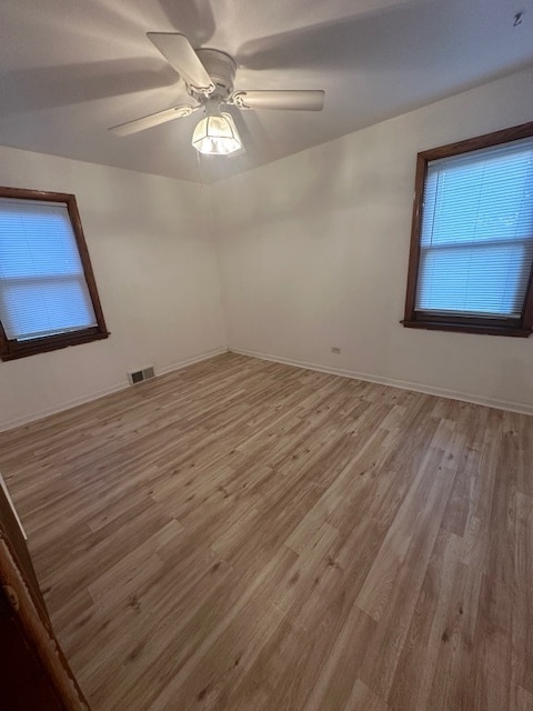 spare room featuring hardwood / wood-style floors and ceiling fan