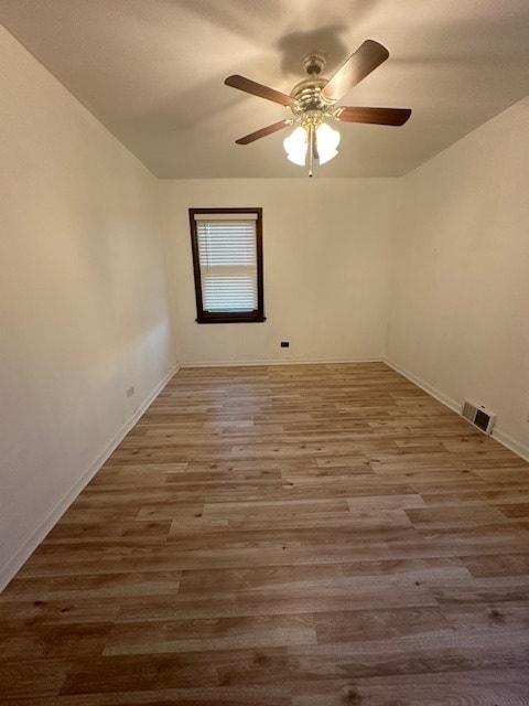 empty room featuring ceiling fan and hardwood / wood-style flooring