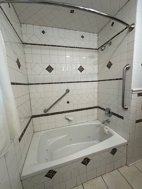 bathroom featuring tile walls, tiled shower / bath combo, and tile patterned flooring